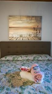 a bed with a painting on the wall at Casa Silvia II mit Seeblick mit Terrasse in Torri del Benaco +28 photos