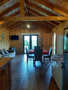 a large living room with a table and chairs at Cabaña Vista Hermosa 6 Personas Conaripe in Panguipulli