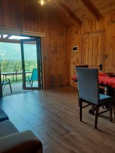 a living room with a bed and a table and chairs at Cabaña Vista Hermosa 6 Personas Conaripe in Panguipulli