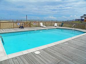 a swimming pool on a wooden deck next to a wooden deck at KD1401D- Kiki's Haven in Kill Devil Hills