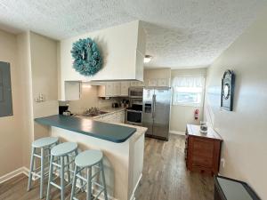 a kitchen with white cabinets and a blue counter top at KD1401D- Kiki's Haven in Kill Devil Hills