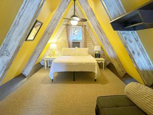 a bedroom with a bed and a yellow wall at CH307- The Pirate House in Kill Devil Hills +22 photos