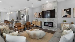 a living room with a couch and a fireplace at Queen Palm in Inlet Beach