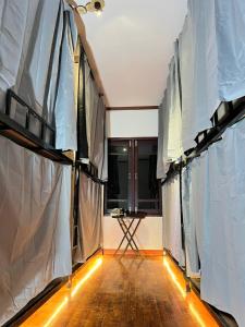 an empty room with curtains and a table in the middle at venn in Vientiane