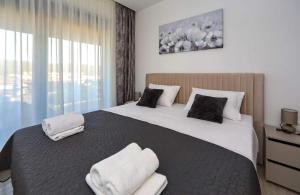 a bedroom with a large bed with towels on it at Sunny Oasis in Bibinje +106 photos