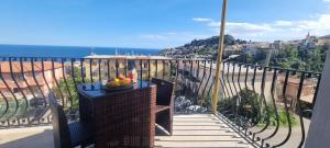 a bowl of fruit on a table on a balcony at LEDA Apartaments in Taormina