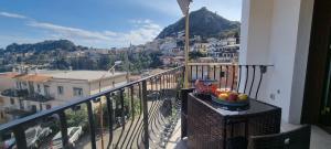 a bowl of fruit on a table on a balcony at LEDA Apartaments in Taormina