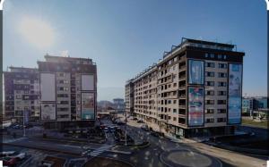 a city with tall buildings and a street with cars at Luxury Lamela Bulevar in Sarajevo