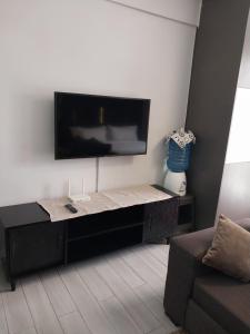 a living room with a flat screen tv on the wall at Hellen's Condo in Nairobi
