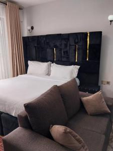 a hotel room with a bed and a couch at Hellen's Condo in Nairobi
