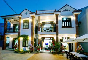 a large white building with christmas decorations in front of it at Countryside Garden Homestay in Hoi An