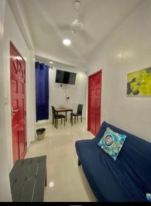 a bedroom with a bed and a dining room with a table at Resting View One Bedroom Apartment in Male City
