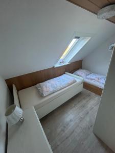 a small room with two beds and a window at Lotus 3 in Cuxhaven
