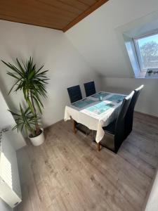 a dining room with a table and a potted plant at Lotus 3 in Cuxhaven