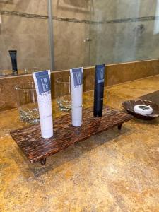 two bottles and two glasses on a wooden tray at The Beach House in Panama City +26 photos