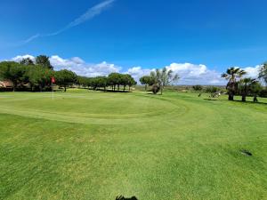 a view of a golf course with a green at Los Colibríes, Beach & Golf - By AC REAL in Isla Canela
