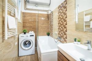 a bathroom with a washing machine and a bath tub at Star House in the city in Budapest