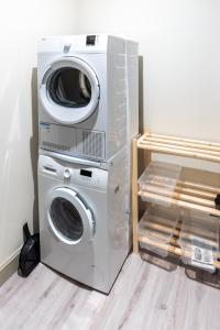 a washing machine and a dryer in a room at T3 Duplex dépendance du Château in Gennes