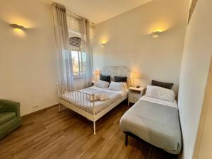 a bedroom with two beds and a window at Enjoy Vatican in Rome