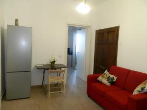 a living room with a red couch and a table at Alma Verde in Narni