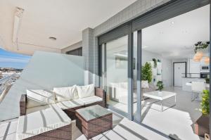 a living room with a couch and a table at Luxury Seaview Beachfront Apartment Pools,Jacuzzi,Gym in Arenales del Sol