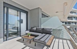 a living room with a couch and a table at Luxury Seaview Beachfront Apartment Pools,Jacuzzi,Gym in Arenales del Sol +55 photos