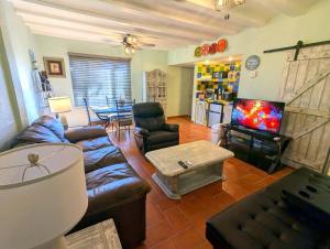 a living room with a couch and a tv at Sea Breeze Retreat 301 in Puerto Peñasco