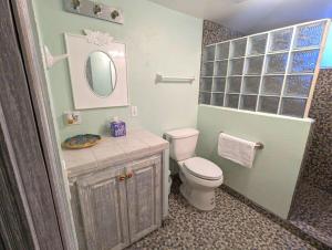 a bathroom with a toilet and a sink and a mirror at Sea Breeze Retreat 301 in Puerto Peñasco +17 photos