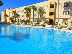 a large swimming pool in front of a building at Sea Breeze Retreat 301 in Puerto Peñasco