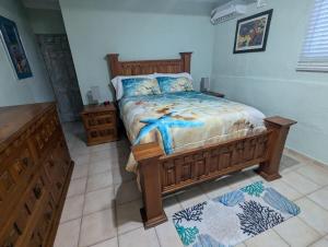 a bedroom with a large bed with a wooden frame at Sea Breeze Retreat 301 in Puerto Peñasco