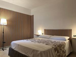 a bedroom with a large bed in a room at Grace 101 in Vigevano