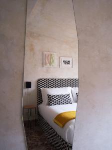 a mirror reflection of a bed in a bedroom at sanfrancesco ventitre in Arezzo +6 photos