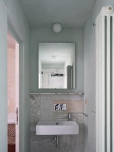 a bathroom with a white sink and a mirror at sanfrancesco ventitre in Arezzo