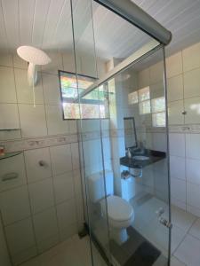 a bathroom with a toilet and a glass shower at Recanto Santa Helena Iriri Santa Helena in Anchieta +61 photos