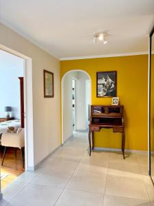 a living room with yellow walls and a desk at Lovely apartment in Albertville in Albertville