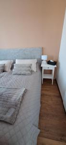 a bedroom with a large bed and a table at Apartmán Ellis in Podhájska