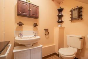a bathroom with a toilet and a sink at Ideal Contractor Stay 2-Bed Near Glasgow Fort in Garthamlock +19 photos