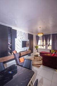 a living room with a couch and a table at 2 Bedroom Furnished Serviced Apartment in Lekki Phase 1 in Lekki