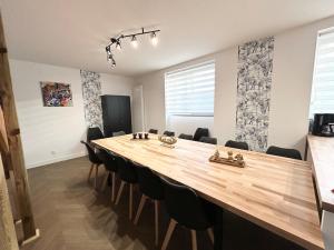 a conference room with a large wooden table and chairs at Jolie maison familiale 14 personnes in Trélazé