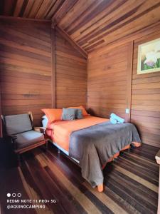 a bedroom with a bed and a chair in it at Aqui no Camping in Brumadinho +40 photos