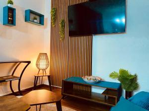 a living room with a tv on a wall at Casa Bucaneve in Camigliatello Silano