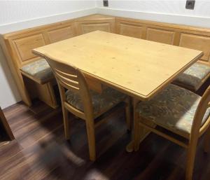 a wooden table and two chairs and a wooden table and chairs at Apart Dornbirn 4, 24 h Checkin, free Internet in Dornbirn