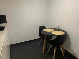 a table and two chairs in a room at Paradiso Apartments - 1 BDR in Oranjestad
