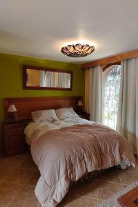 a bedroom with a large bed and a window at Posadas del Castillo del Titicaca in Vencalla