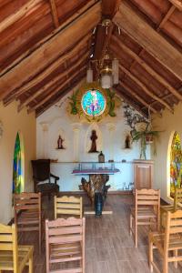 a church with a table and chairs and a stained glass window at Posadas del Castillo del Titicaca in Vencalla +17 photos