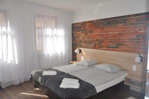Postel nebo postele na pokoji v ubytování Apartamenty Przy Starówce