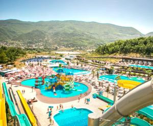 an image of a water park with people in it at Tirana Sunset Retreat Stylish Loft by the Lake Park in Sauk