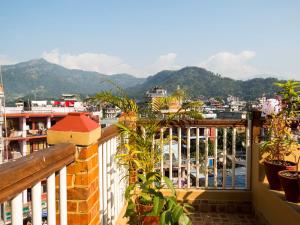a balcony with a view of a city and mountains at Tristar Hotel in Pokhara