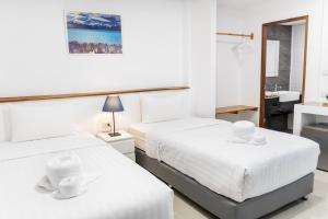 two beds in a white room with a sink at Grand Sattahip Hotel by BSH in Ban Nong Sa +36 photos
