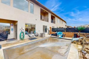 a swimming pool in the backyard of a house at Zion Village Getaway in Hurricane